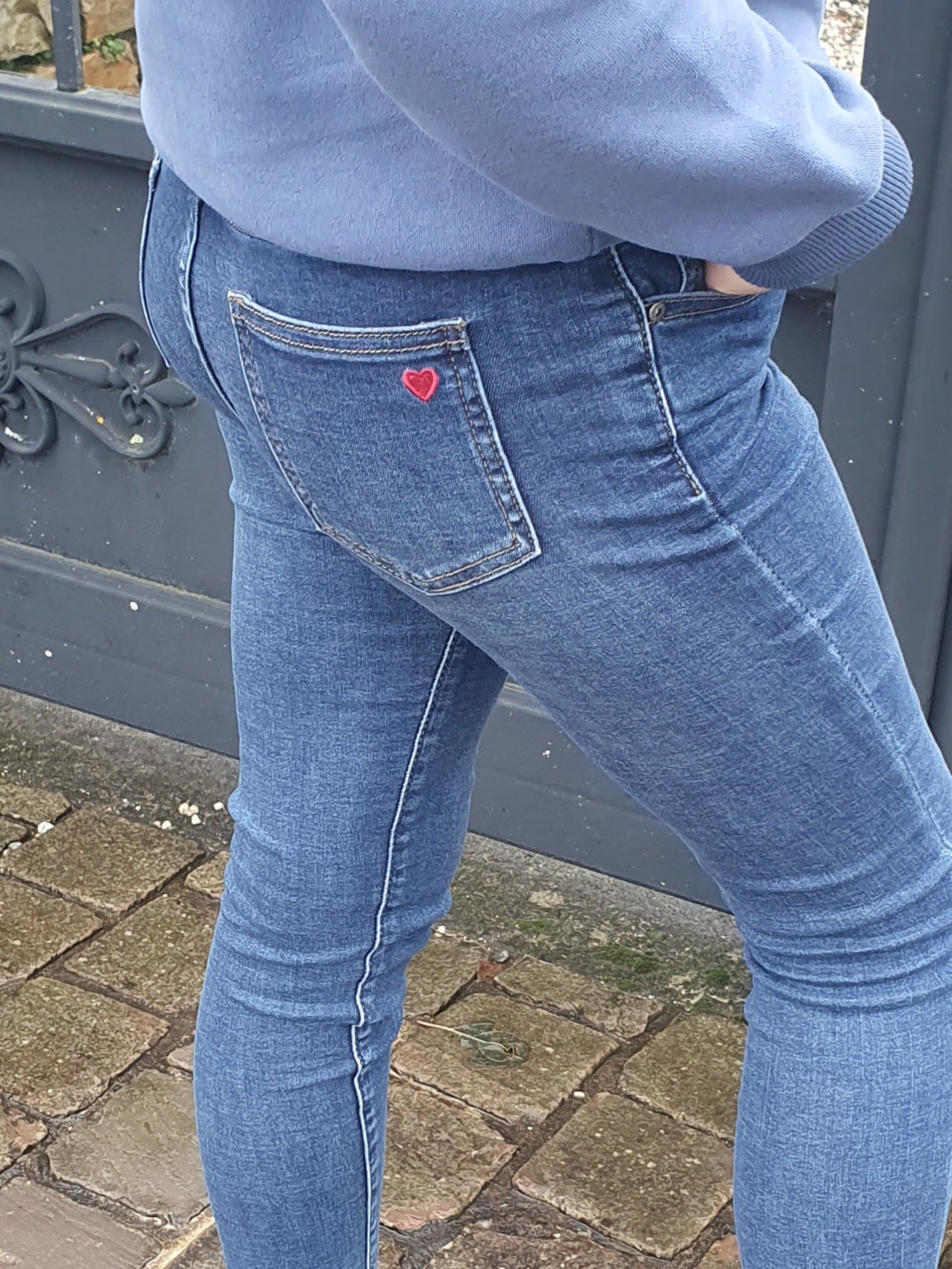 Jean slim fille avec coeur rouge brodé sur poche arrière